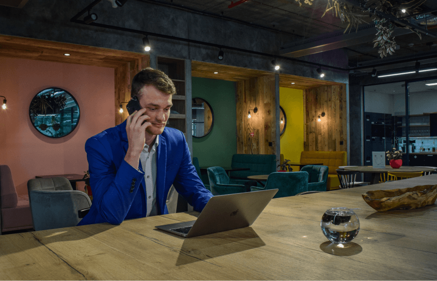 Mr. Šimeček in a suit talking to a client on the phone